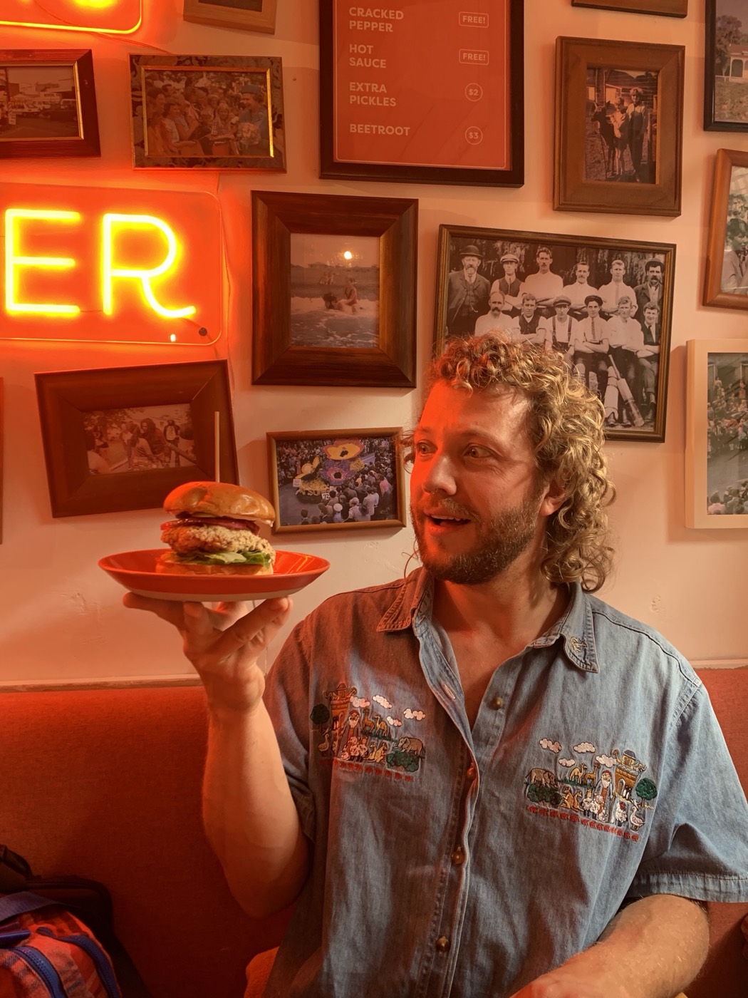 Customers dining inside Community Burgers restaurant in Napier