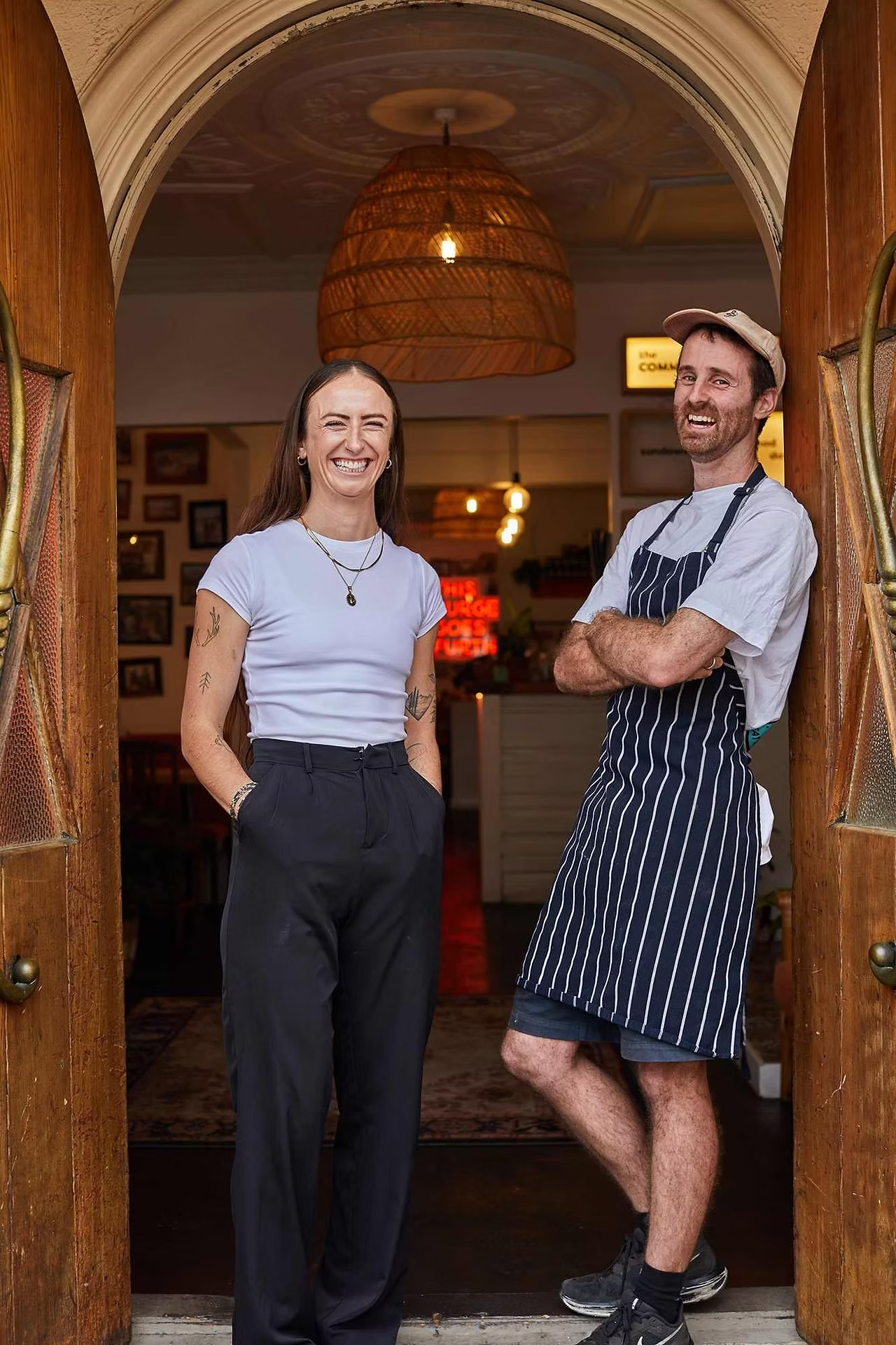 Community Burgers founders standing in the restaurant entrance
